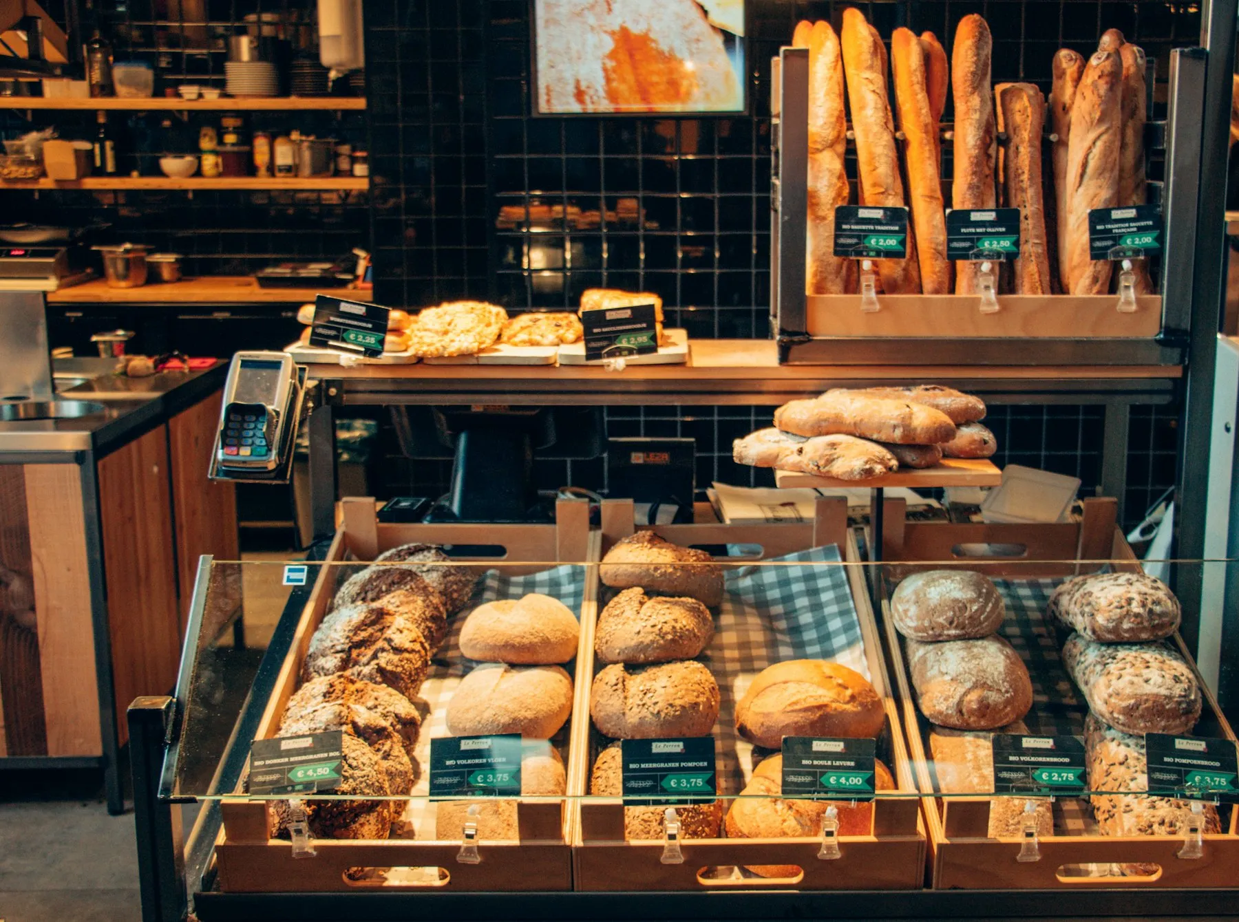 Bakery counter display filled with artisan loaves